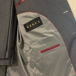 Gray suit that has some dark gray stripes on it as well.